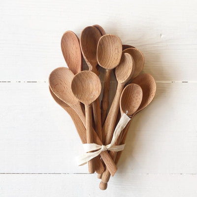 Set of 13 small wooden spoons with various shapes and sizes. 