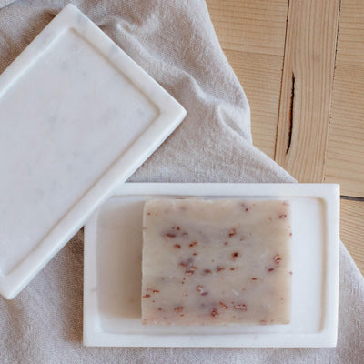 White marble soap plate displayed with bar soap. 