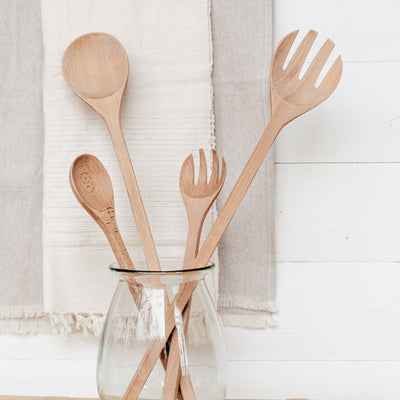 Large and small beechwood salad servers displayed in glass jar.